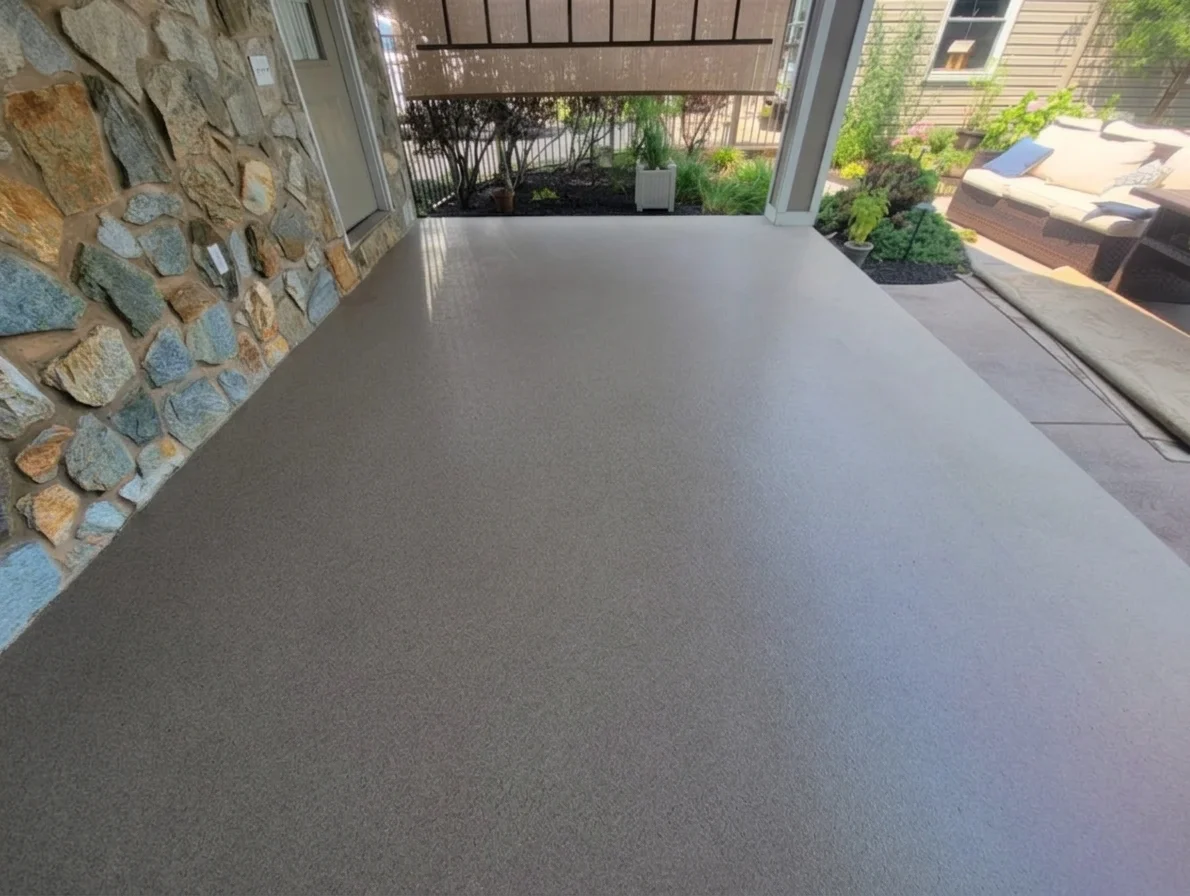 Quartz finish on a covered patio beside a stone wall